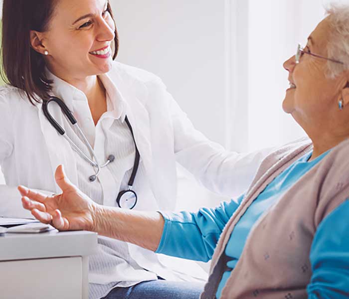 Lady Patient talking happily to a doctor